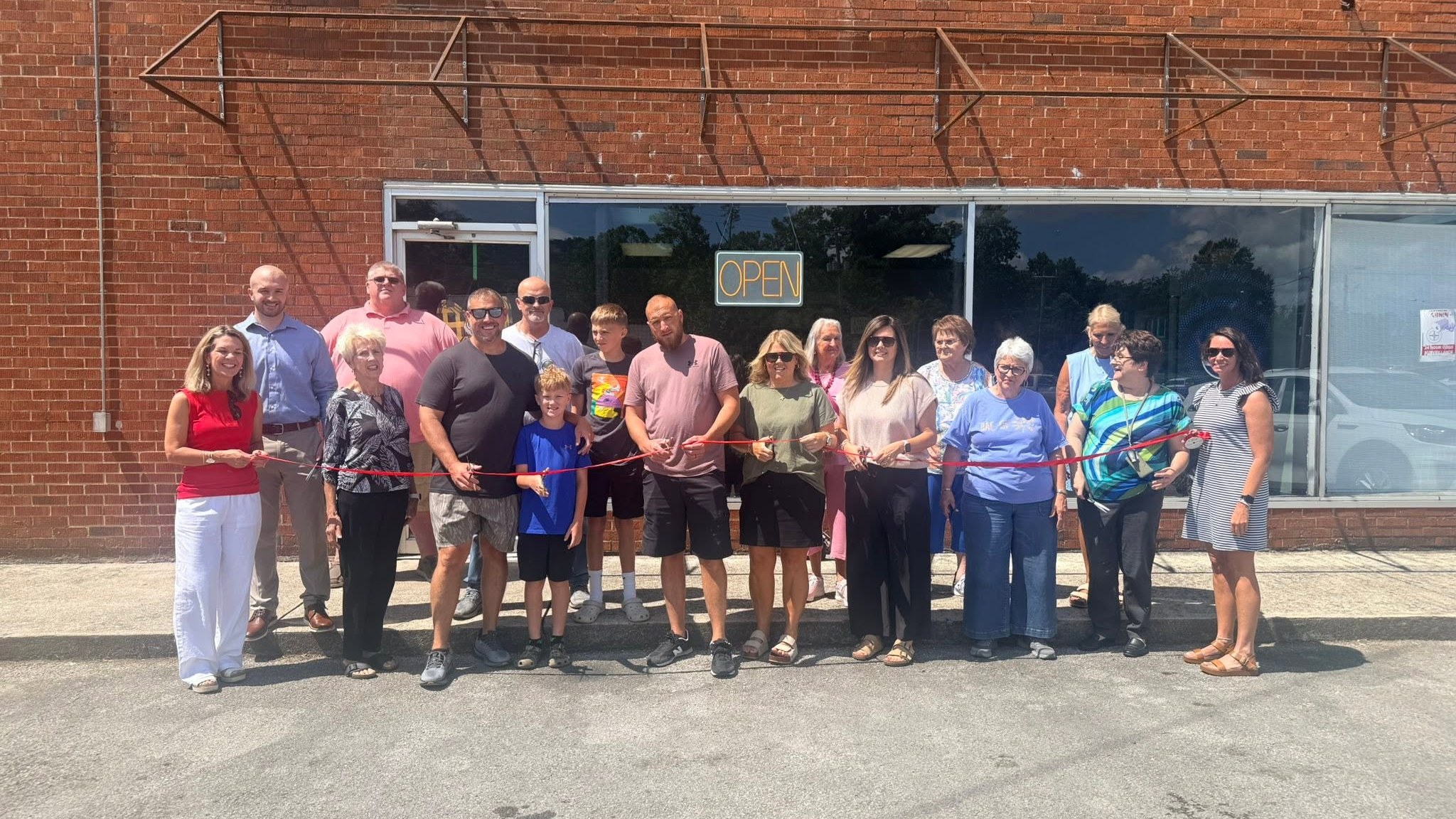 Chamber members and business owners at a ribbon cutting in downtown Manchester