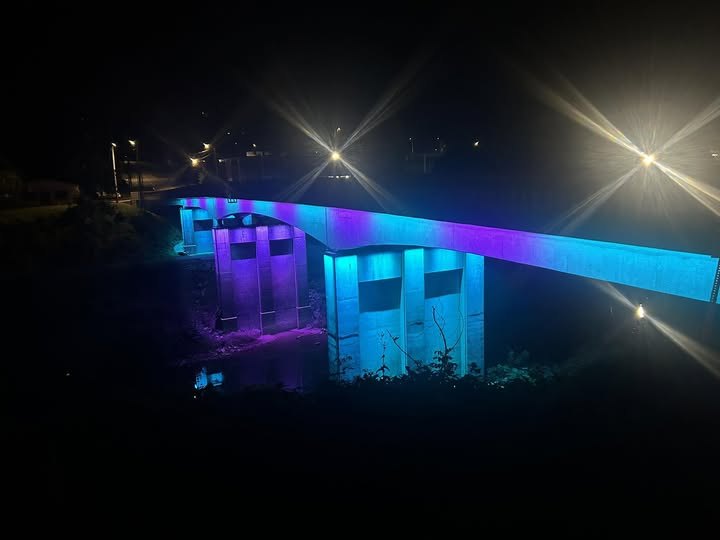 Manchester swinging bridge lit up at night